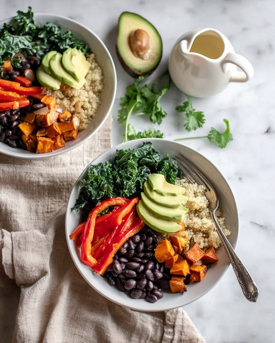 Two white bowls sit on a white marbled surface, each filled with layers of colorful healthy food. Each bowl contains five layers: bright green leafy kale on one side, next to dark black beans, then several slices of pale green avocado resting on a bed of light tan quinoa. On the opposite side of the kale are red bell pepper slices and bright orange roasted sweet potato cubes mixed with light golden cooked onions. A silver fork lays inside the front bowl, resting on the edge. Nearby is a halved avocado, a white pitcher with light dressing, and some green leaves. A soft beige cloth adds texture under the bowls. Photo taken with an iphone --ar 4:5 --v 7