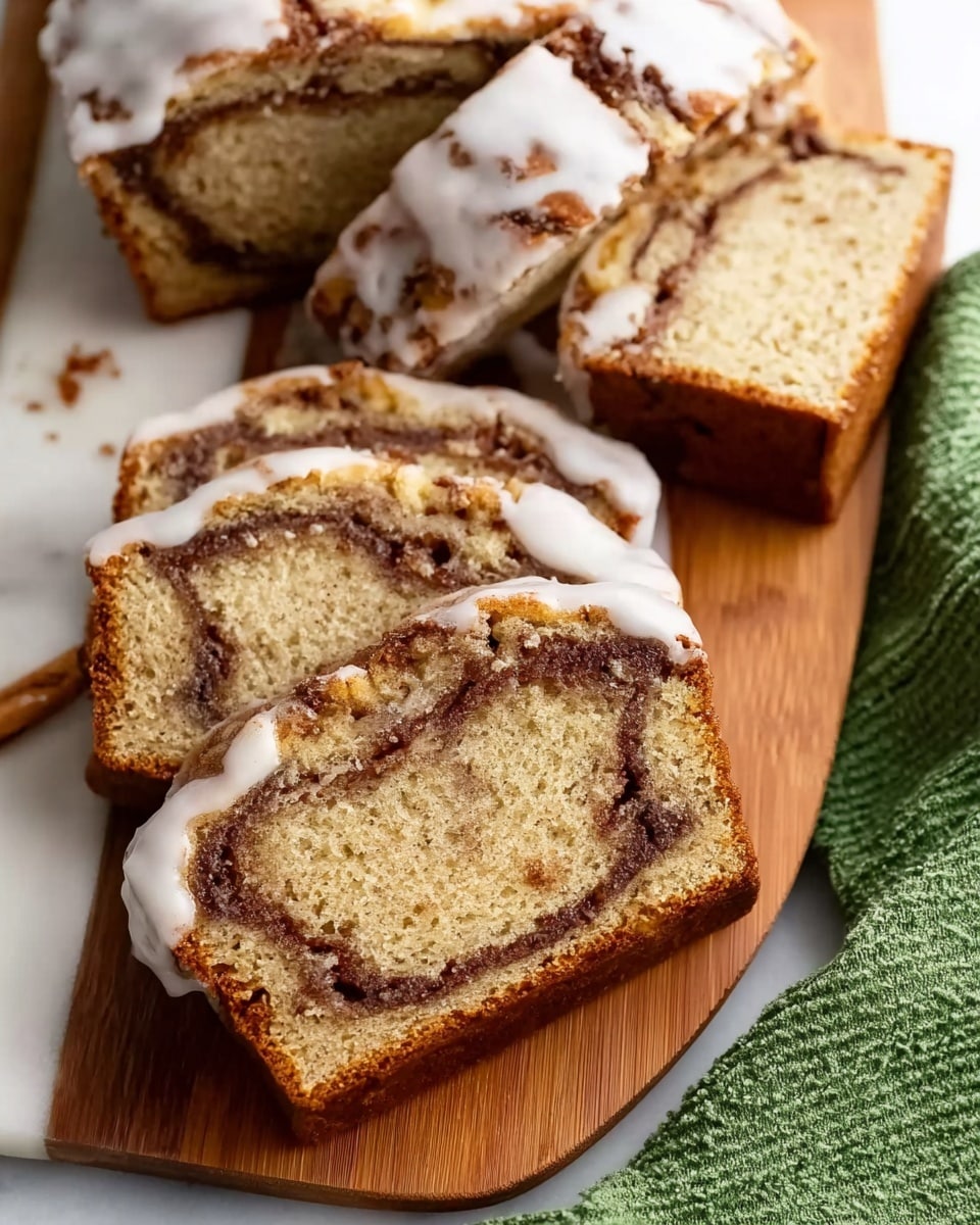 The image shows slices of cinnamon swirl bread with a light brown texture and dark brown cinnamon swirls inside each slice. The bread has a soft, moist look with a white icing glaze drizzled unevenly on top, creating a shiny contrast against the bread. The slices are placed on a white marbled surface and on a wooden board, with part of a green cloth visible nearby. The edges of the bread are golden brown, showing a slightly firm crust. Photo taken with an iphone --ar 4:5 --v 7