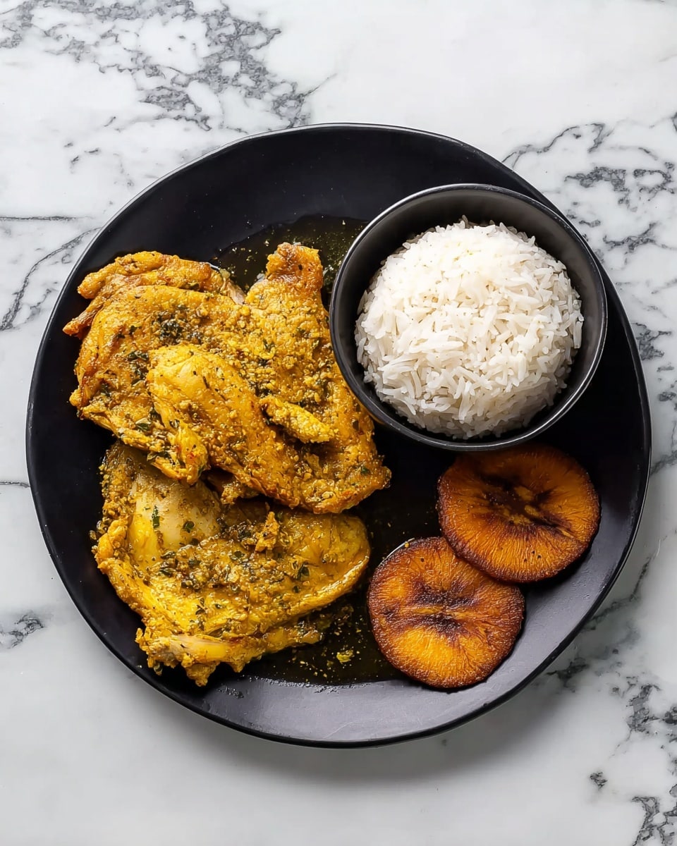 A black plate is arranged with three main parts: on the left, two pieces of yellowish spiced chicken with visible herbs and some sauce around them; below the chicken, two small browned fried plantains with a slightly crispy texture; on the right, a small black bowl filled with white rice that has a fluffy texture. The plate is set on a white marbled surface. photo taken with an iphone --ar 4:5 --v 7
