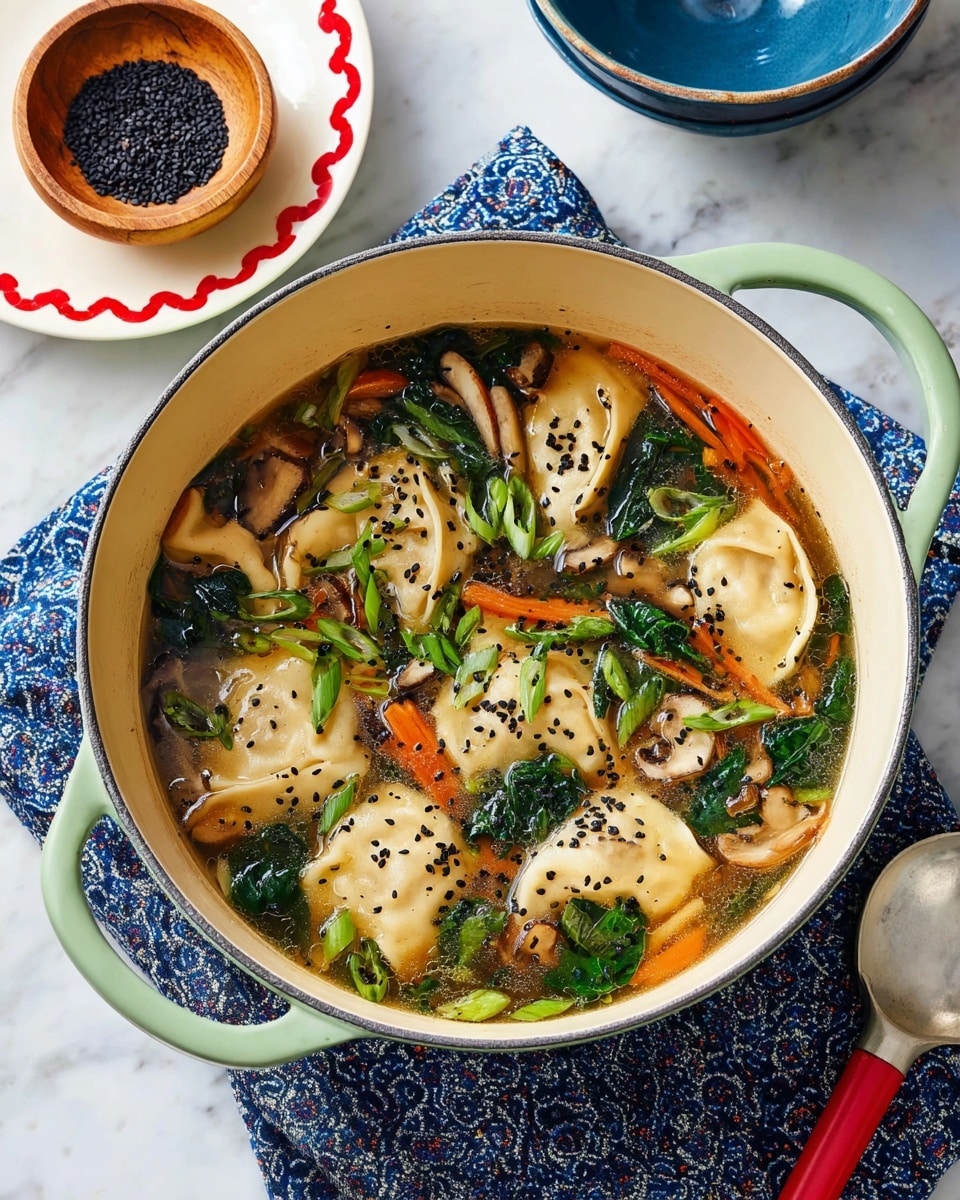 A white pot with light green handles holds a warm broth filled with several light beige dumplings floating on top. The soup also has dark green spinach leaves, thin strips of orange carrot, and sliced brown mushrooms scattered throughout. Bright green chopped scallions and black sesame seeds are sprinkled on the surface, adding contrast to the mix. The pot sits on a blue patterned cloth on a white marbled surface. Nearby, a small wooden bowl contains more black sesame seeds on a white plate with a red scalloped edge, and there is a blue bowl with a silver spoon with a red handle to the right. The photo taken with an iphone --ar 4:5 --v 7