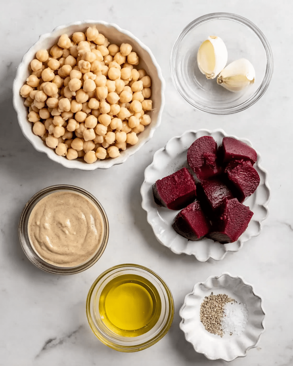 The image shows seven bowls arranged on a white marbled surface. The largest white bowl at the top left is full of light beige chickpeas with a smooth, round texture. To its right, a small clear bowl holds two whole garlic cloves. Below the chickpeas, near the center, a white bowl contains three dark red beet pieces with a rough texture. To the left of the beets, a small white bowl is filled with thick, light brown tahini sauce. Below the tahini, there is a small clear bowl of golden olive oil, and next to it on the right, another small clear bowl holds pale yellow lemon juice. At the bottom right, a small white bowl with scalloped edges contains white salt and black pepper mixed together as a fine sprinkle. The photo taken with an iphone --ar 4:5 --v 7