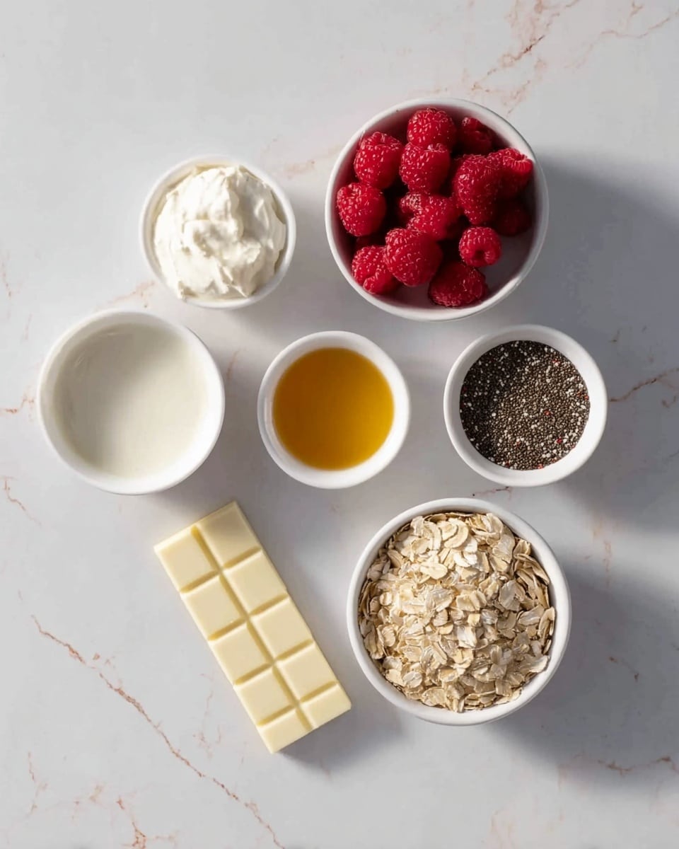 The image shows six small white bowls arranged in a loose circle on a white marbled surface, each holding different ingredients. Starting from the top and moving clockwise, the first bowl contains a dollop of soft white cream, the second holds bright red raspberries tightly packed. Below this, a rectangular piece of white chocolate with three squares is placed directly on the surface. Next, another bowl contains a smooth white liquid. Moving up, one bowl holds a golden liquid, likely honey or syrup. Finally, a bowl filled with tiny black chia seeds is visible, and another has dry rolled oats with a light beige color. The lighting is soft and natural, with no shadows, photo taken with an iphone --ar 4:5 --v 7
