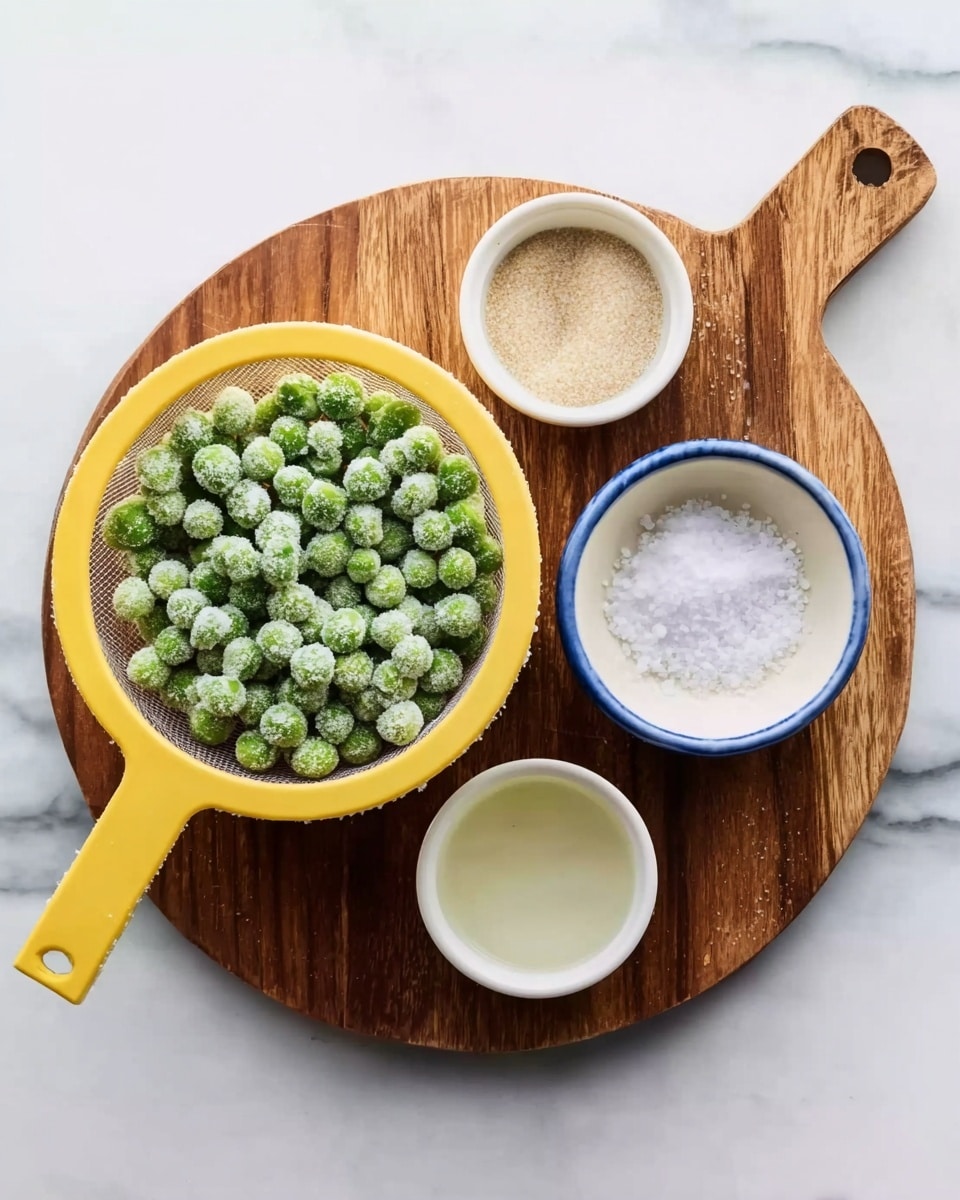 The image shows a round wooden board placed on a white marbled surface. On the board, there is a yellow strainer filled with frozen green peas, the peas appear frosty and tightly packed in one layer inside the strainer. Around the strainer, there are three small white bowls: one containing a fine beige powder, another with coarse white salt, and the third with a clear liquid, each bowl holding a single even layer of their contents. The colors contrast well with the wood and the white marbled background, creating a clean and orderly arrangement. photo taken with an iphone --ar 4:5 --v 7