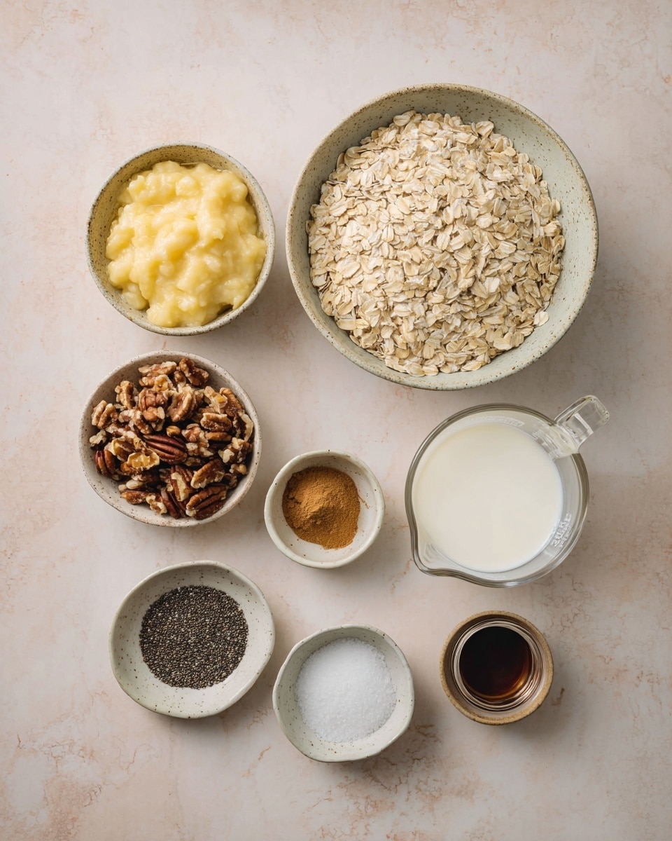 A top-down image shows nine containers with different ingredients arranged on a soft light beige surface. In the center is a large bowl filled with pale, dry rolled oats. Below it on the left is a medium bowl with mashed yellow bananas, smooth and creamy. To the left of the oats is a small bowl with chopped brown pecans, showing rough textures. Above it is a tiny white bowl holding medium brown ground cinnamon powder. To the right of the oats are two clear glass measuring cups, one with thick white yogurt and the other with white milk. Below the measuring cups are three small bowls; one with black chia seeds, one with dark brown liquid maple syrup, and one with dark vanilla extract. The smallest bowl near the top right contains white salt. All bowls are rustic and speckled, placed on a white marbled textured surface, photo taken with an iphone --ar 4:5 --v 7