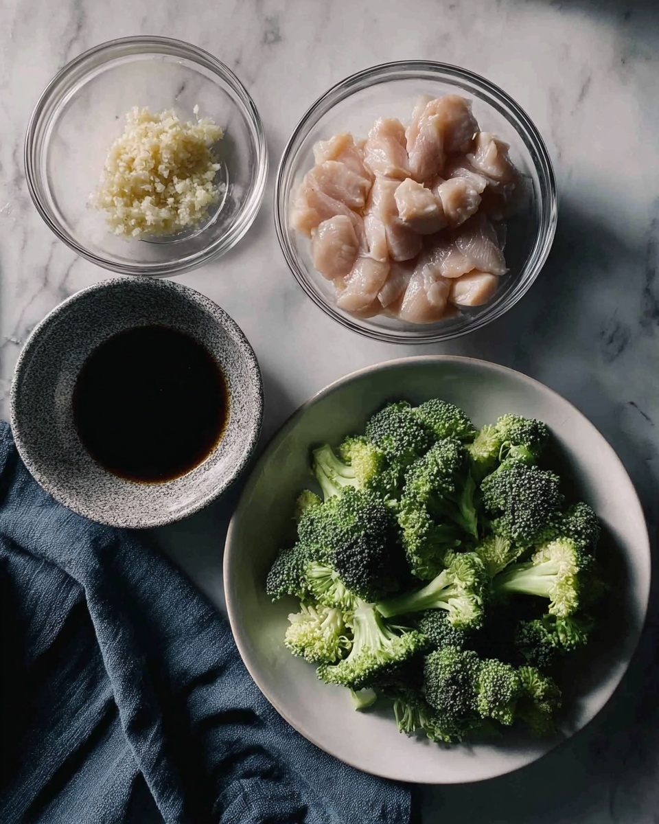 The image shows four clear bowls and one white plate placed on a white marbled surface. The white plate on the right side is filled with cut broccoli, showing dark and light green florets with some light green stems. Below the plate is a piece of dark blue fabric. In the middle bottom, there is a clear bowl filled with pale pink raw chicken pieces. To its top left, there is another clear bowl with light beige minced garlic. On the far left, there is a speckled grey bowl filled with dark brown soy sauce. The scene is softly lit and has a natural, fresh cooking feel. Photo taken with an iphone --ar 4:5 --v 7