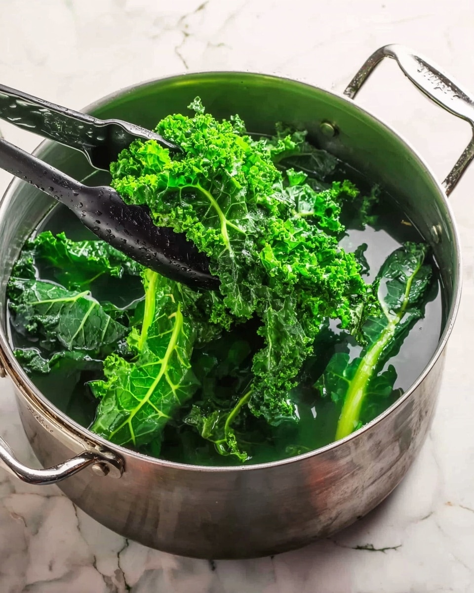 A large silver pot filled with clear water is shown on a white marbled surface, with bright green kale and spinach leaves being lifted from the water using black tongs held by a woman's hand on the left side of the image. The leaves appear fresh and slightly wet, with curly and smooth textures visible in the kale and spinach respectively. The pot has two handles and shows a bit of steam or moisture on its inner surface. Photo taken with an iphone --ar 4:5 --v 7