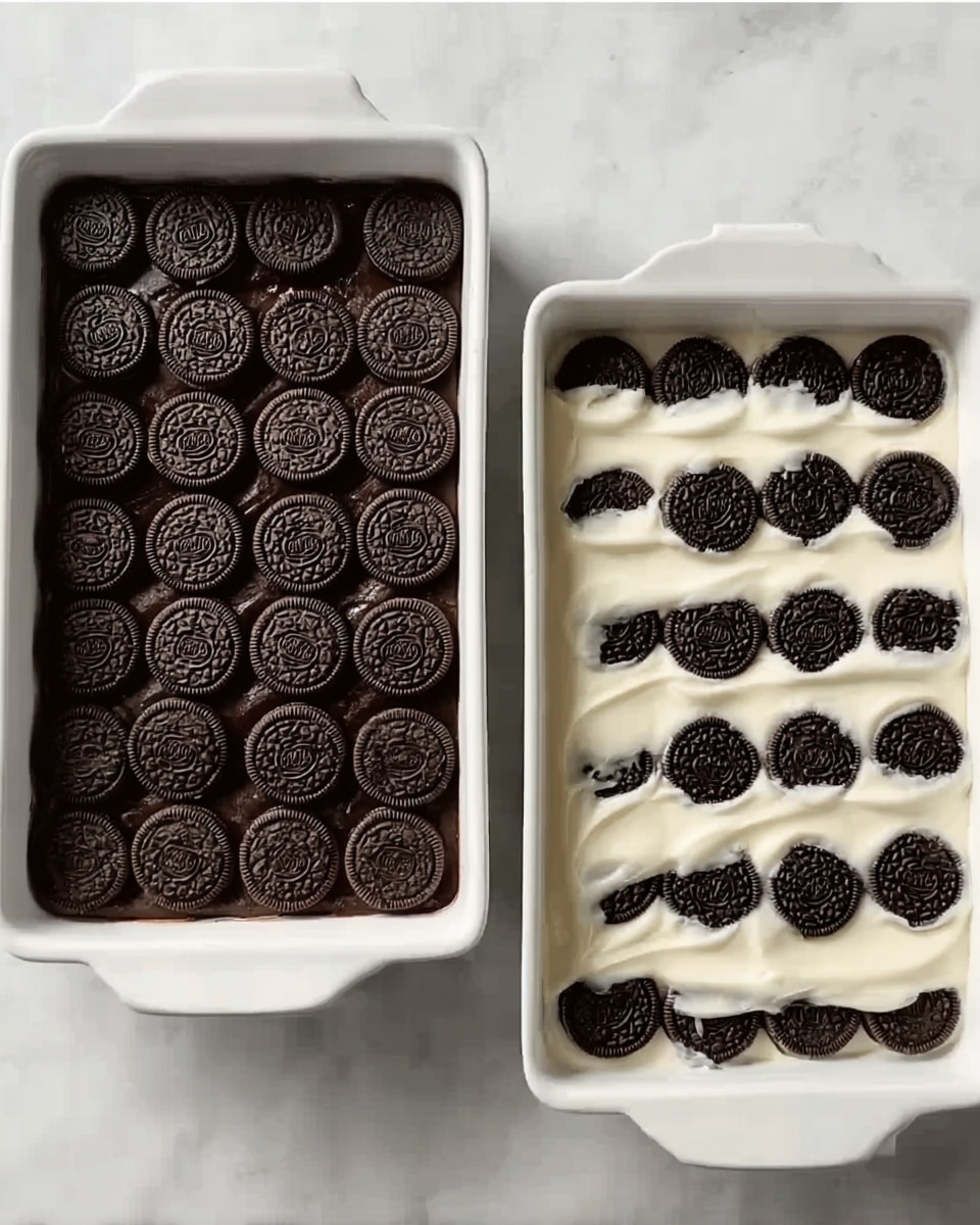 The image shows two rectangular white ceramic baking dishes on a white marbled surface. The dish on the left is filled with two neat rows of small round dark chocolate cookies placed in a single even layer, covering the whole bottom. The dish on the right has the same cookies but they are partly covered with a smooth, thick white cream spread evenly over the cookies, with some cookie edges visible along the sides. Photo taken with an iphone --ar 4:5 --v 7