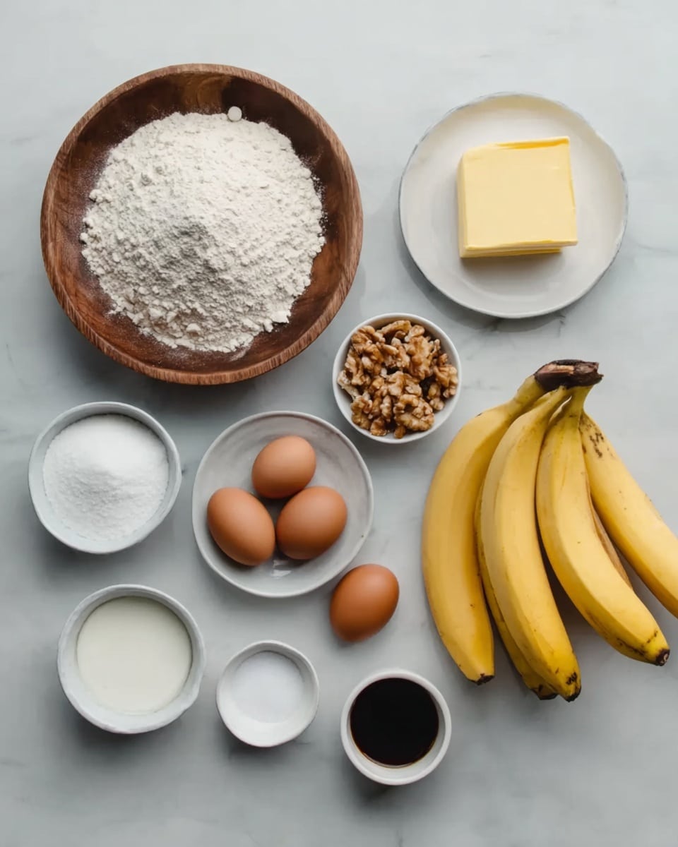 The image shows several bowls and a bunch of bananas placed on a white marbled surface. There is a large wooden bowl filled with white flour on the left side. To its right, there is a small white bowl with chopped nuts, a white plate holding a yellow stick of butter, and three yellow bananas lying close together. Below these, there is a white bowl with white sugar, a small white bowl with salt, a small bowl with a white powder, a small cup filled with a dark brown liquid (vanilla extract), and a small white bowl holding two brown eggs. All items are arranged neatly and spaced out evenly. Photo taken with an iphone --ar 4:5 --v 7