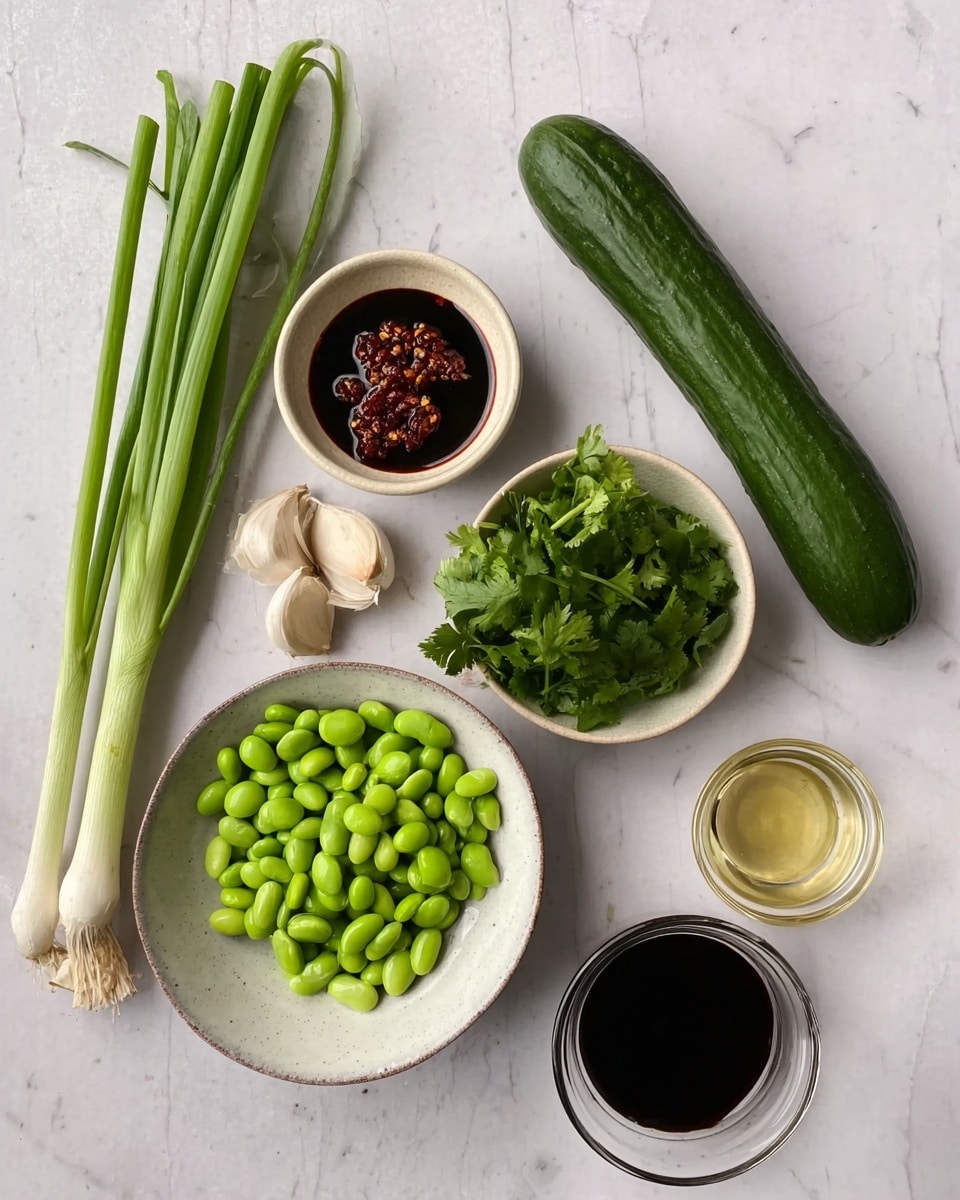 The image shows a flat lay of fresh ingredients on a white marbled surface. There are two green onions with white bulbs at the top left, a long dark green cucumber on the right side, and a small white plate with green edamame beans at the bottom left. A small white bowl holds dark red chili sauce with visible chili flakes near the upper middle part. Below it, a white bowl contains fresh green cilantro leaves. Near the cucumber, a small beige dish holds two garlic cloves. Two small clear glass bowls contain a light golden liquid and a dark soy sauce, placed near the bottom right. The overall layout is tidy and colorful with a mix of green, white, red, and beige tones. Photo taken with an iphone --ar 4:5 --v 7