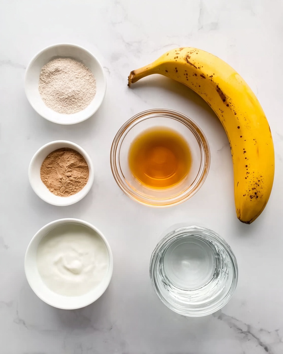 The image shows six items on a white marbled surface arranged neatly. Starting from the top right, there is a ripe yellow banana with some brown spots on its skin. Below the banana, there is a small clear glass bowl with a light brown liquid inside. On the bottom left, a white bowl contains a powder mix of light brown and white. Above it, a small white bowl holds a golden amber liquid. To the left of the liquid, a small white bowl contains a thick white cream. In the center, a clear glass jar is filled with clear water. The photo is taken from above with soft lighting, creating a clean and minimal look photo taken with an iphone --ar 4:5 --v 7