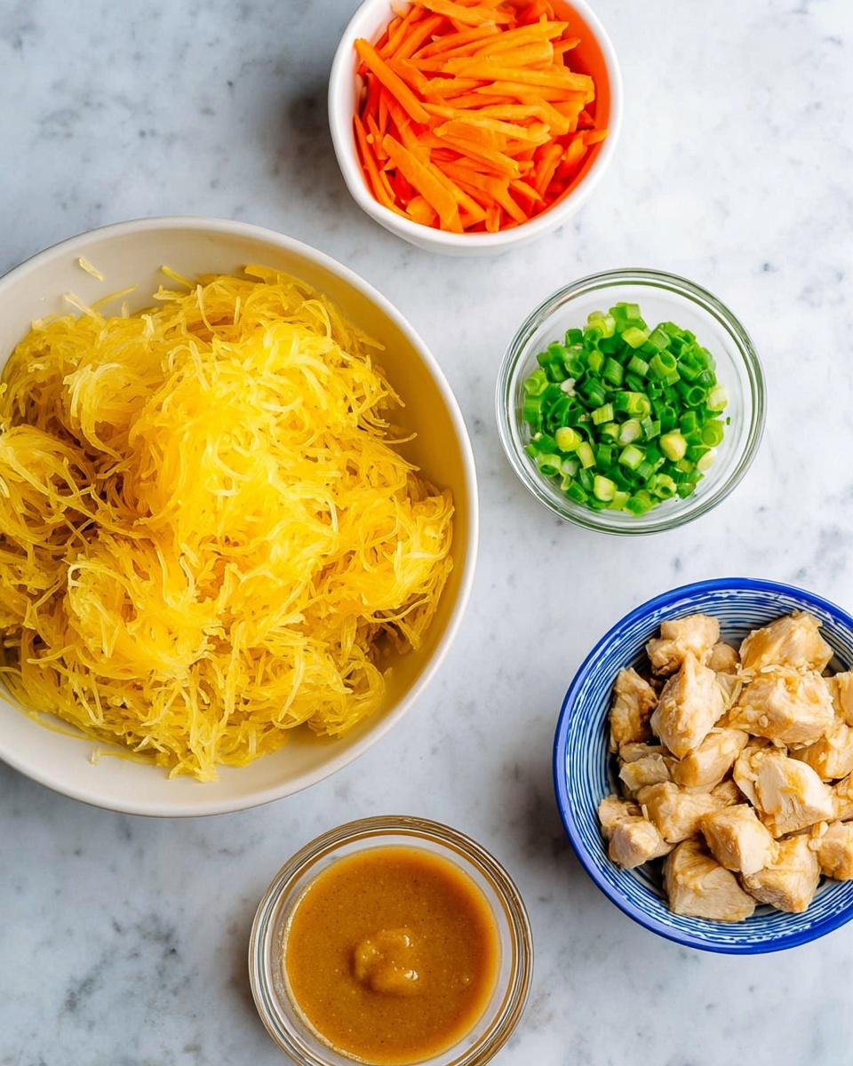 The image shows four white bowls placed on a white marbled surface. The largest bowl holds a nest of yellow spaghetti squash strands with a soft, slightly wet texture. To the left, a smaller white bowl is filled with thin orange carrot sticks mixed with small light-colored onion pieces. Below that, there is a small clear glass cup containing a thick, light brown sauce. On the right, another white bowl with a blue rim contains small cooked light tan chicken pieces with a slight sear. Above, a small clear glass bowl is filled with chopped bright green scallions. photo taken with an iphone --ar 4:5 --v 7