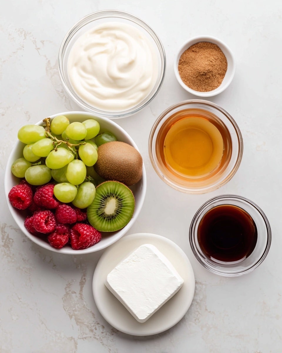 The image shows six separate items arranged on a white marbled surface: a large white bowl filled with a mix of fresh fruits including green grapes, red grapes, sliced green kiwi, whole brown kiwi, and red raspberries; next to the fruit, a clear glass bowl contains a smooth, creamy white mixture; above it, a small white bowl holds a small pile of brown powder; to the right, a white bowl is filled with a golden-brown liquid; below that, a white bowl has a square block of soft white cheese; and finally, a small clear glass holds a dark brown liquid. photo taken with an iphone --ar 4:5 --v 7