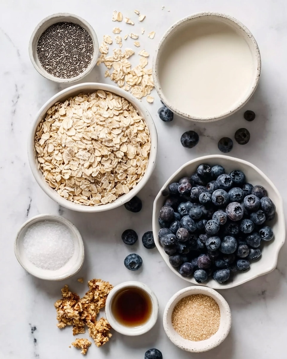 The image shows a top view of several white bowls and a small plate arranged on a white marbled surface. The largest white bowl in the center contains light beige rolled oats. To the right, a small white plate is filled full of fresh dark blue blueberries, with some loose ones scattered around. Above the oats bowl, a medium white bowl contains a creamy white liquid, likely milk or yogurt. To the left, a small white bowl holds tiny black chia seeds. Near the top right, a very small white bowl holds a light brown powder, and next to it, another tiny white bowl contains white salt. At the bottom left, a tiny bowl holds a dark brown liquid, perhaps vanilla extract or syrup. Near the bottom center, there is a small cluster of crumbly granola. The overall scene looks clean and fresh, with a focus on natural colors and textures. photo taken with an iphone --ar 4:5 --v 7
