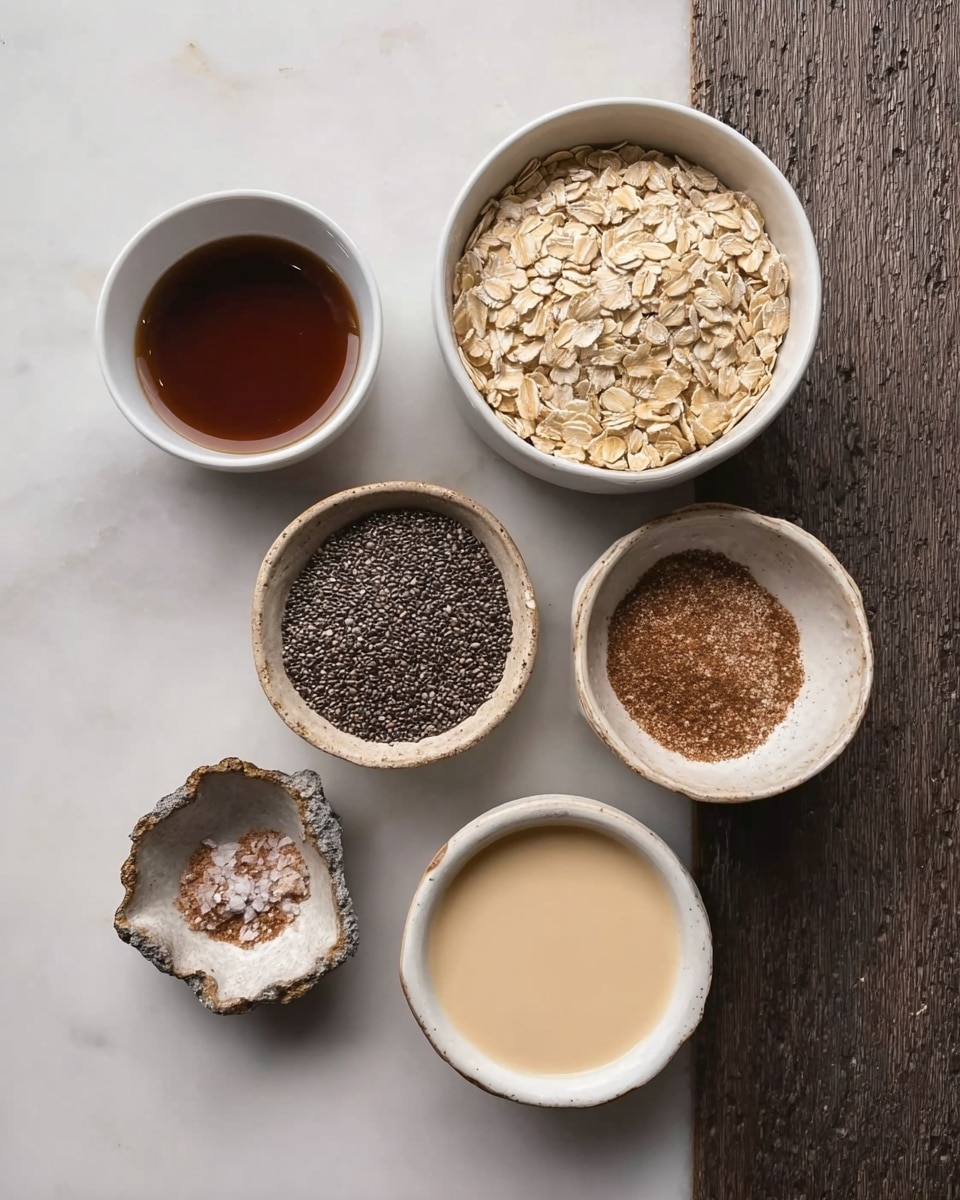 The image shows six small white bowls arranged on a white marbled surface, each filled with different ingredients. From top left to bottom right, there is a small bowl with dark brown liquid, a bigger bowl filled with light brown rolled oats, a bowl with a fine brown powder, another bowl with black chia seeds, a bowl with creamy beige liquid, and a very small rough-edged bowl holding a small amount of brown powder and salt. The bowls are simple and clean, with different textures from smooth liquid to grainy seeds and powder. photo taken with an iphone --ar 4:5 --v 7