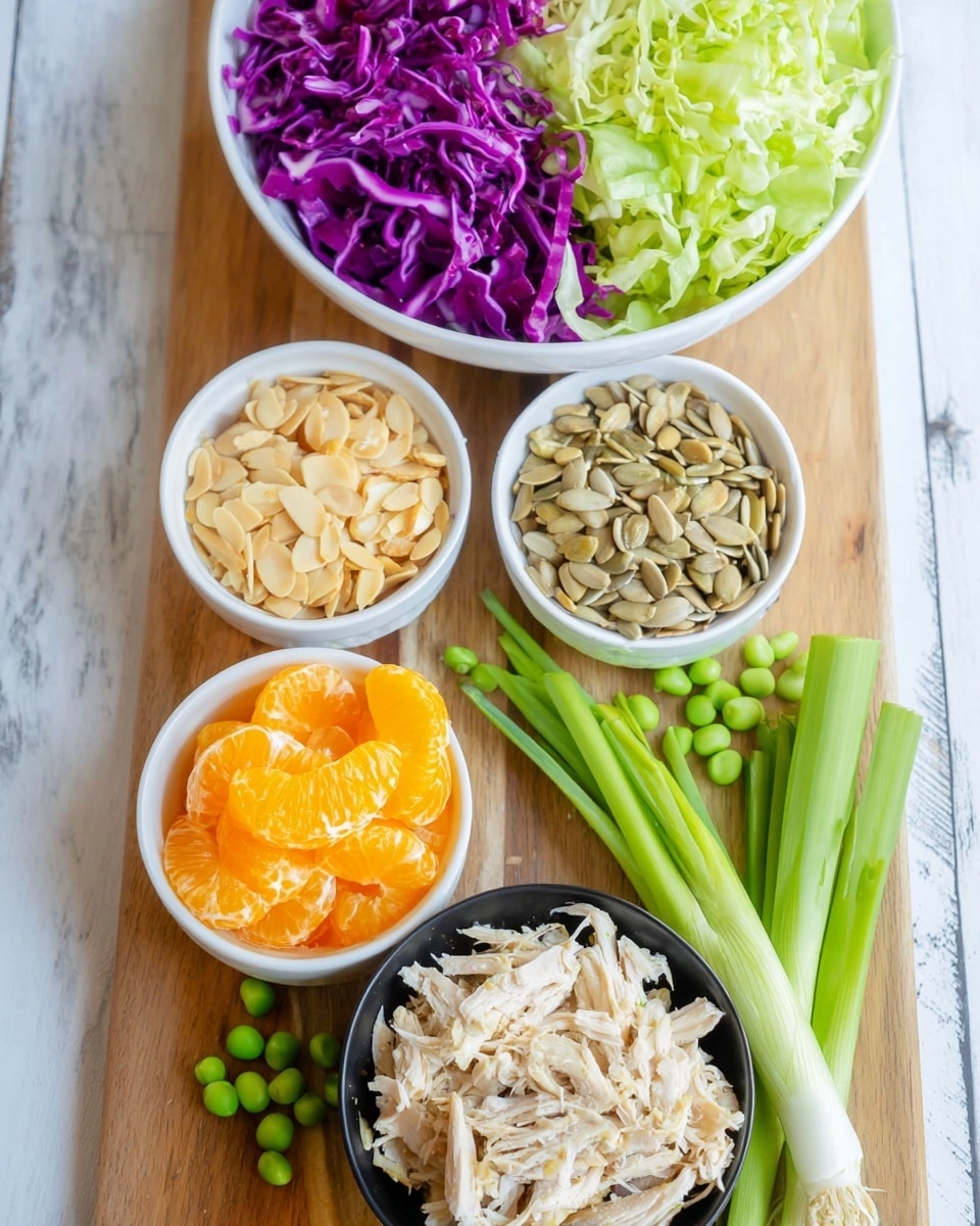The image shows several white bowls and a black bowl arranged on a wooden board with green peas scattered around. At the top, there is a white bowl filled with two layers of shredded purple cabbage on the left and light green lettuce on the right. Below it, there are two small white bowls side by side, with sliced almonds in the top bowl and sunflower seeds in the bottom bowl. Next to these, another small white bowl holds bright orange mandarin slices. At the bottom, a black bowl contains shredded light-colored chicken, and next to it lie two green onions on the wooden board. The background is a white marbled surface. Photo taken with an iphone --ar 4:5 --v 7