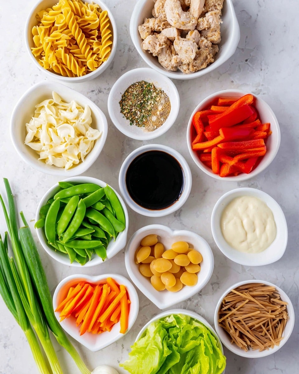 A collection of small white bowls arranged on a white marbled surface, each filled with different ingredients: one bowl holds light brown cooked chicken pieces with visible herbs, another has uncooked yellow spiral pasta, and one contains smooth pale round discs. There are bright green sugar snap peas in another bowl, next to a few with bright red bell pepper strips and fresh green lettuce leaves. Other bowls show creamy white sauces, one slightly thicker and yellowish, and a dark soy-like liquid. A small heart-shaped dish holds ground spices and sesame seeds, while another bowl contains thin, bright orange carrot strips, and one is filled with brown crunchy noodle sticks. A bunch of fresh green onions with white roots lies at the bottom left. The photo taken with an iphone --ar 4:5 --v 7