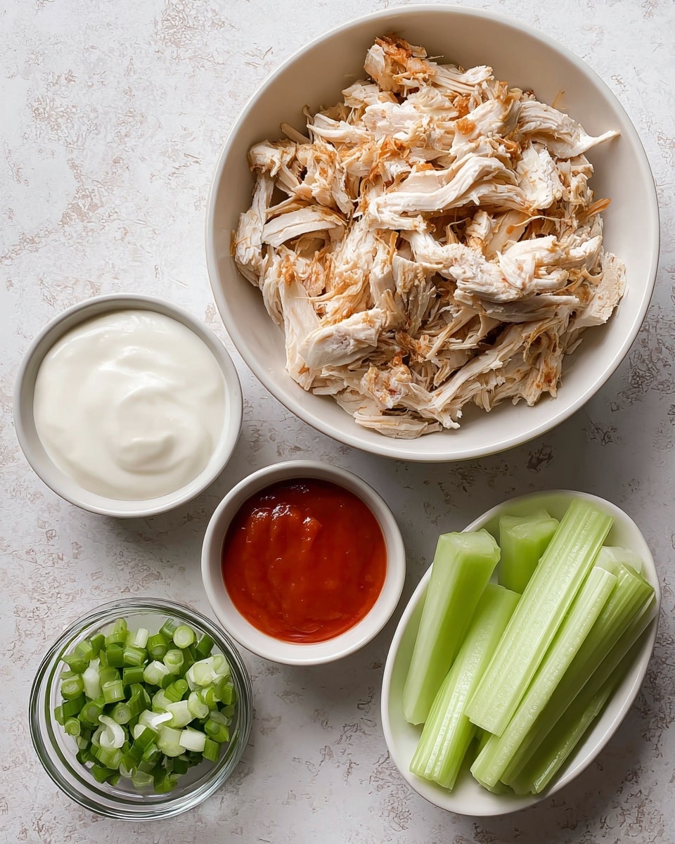 A white bowl filled with shredded cooked chicken featuring light beige and brown crispy pieces sits at the top center. Below it, three smaller white bowls hold different items: to the left, a bowl of thick, smooth white sauce; in the middle at the bottom, a small clear bowl with chopped green onions showing various shades of green and white; to the right, a bowl with smooth, bright red sauce. On the right side near the bottom, another white bowl contains thick, pale green celery sticks with a fresh texture. The dishes are placed on a white marbled surface, arranged neatly and bright in natural light. photo taken with an iphone --ar 4:5 --v 7