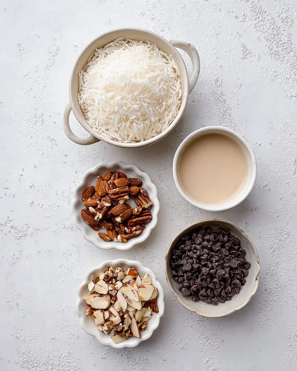 The image shows five small white dishes arranged on a white marbled surface. The top left dish is a small white bowl with a handle, filled with shredded white coconut. To its right is a small white cup filled with a creamy light beige liquid. Below the coconut bowl, two small white scalloped bowls hold chopped nuts; the left bowl contains darker brown nuts, while the right bowl contains a mix of light brown and beige chopped almonds. To the right of these two bowls is a round white bowl filled with dark chocolate chips. All bowls are placed in a neat layout, showing texture and color differences clearly. Photo taken with an iphone --ar 4:5 --v 7