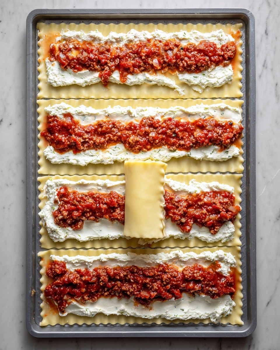 The image shows six long, flat strips of pale yellow lasagna noodles laid out on a gray baking tray atop a white marbled surface. Each noodle strip is evenly spread with a creamy white layer of ricotta cheese, topped with an uneven layer of chunky red meat sauce that has bits of cooked meat and diced onions. One of the middle noodle strips is rolled up into a tight cylinder, showing the smooth edges of the noodle. The red sauce spots contrast with the thick white ricotta, creating a textured, layered look on each noodle. Photo taken with an iphone --ar 4:5 --v 7