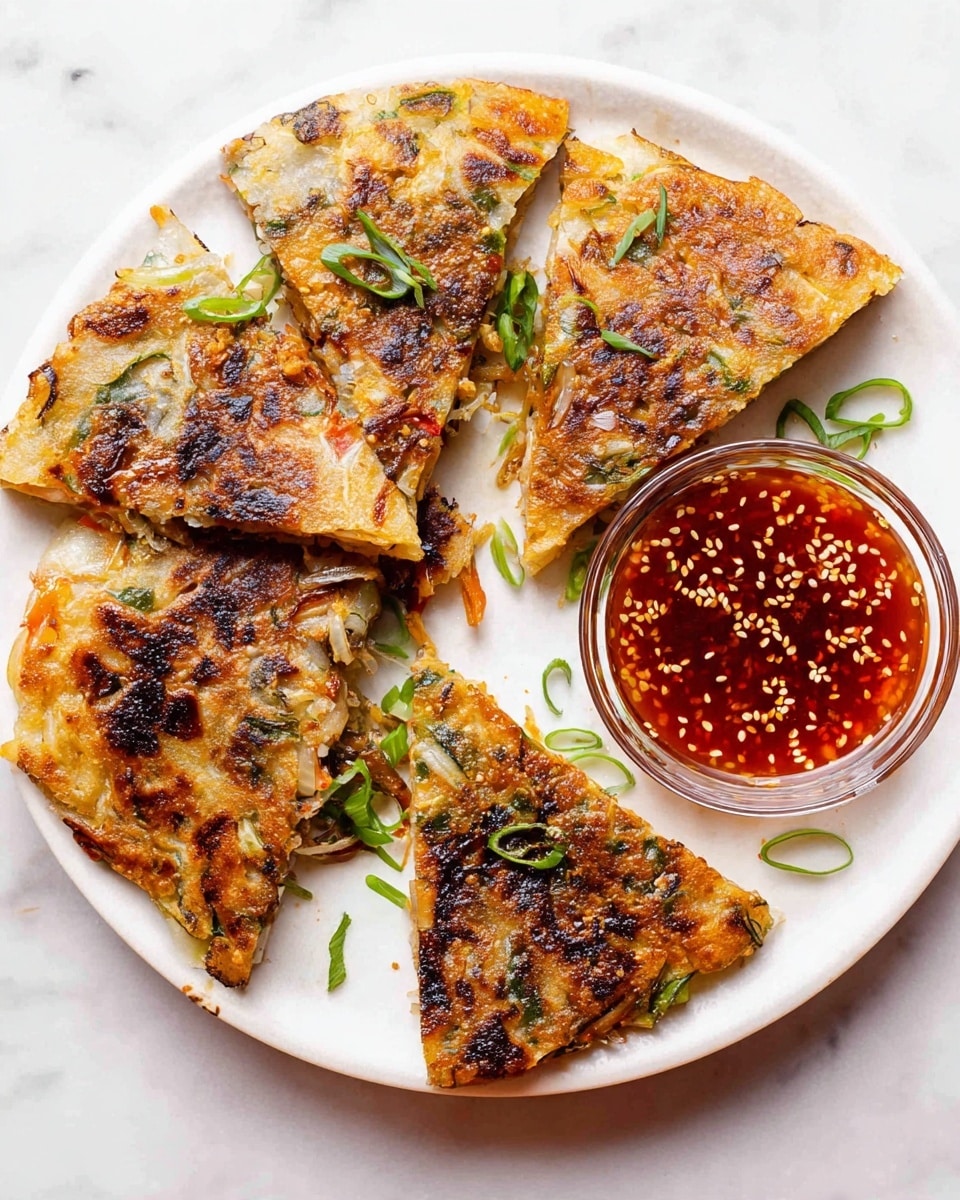 The image shows five pieces of a savory pancake, each cut into a quarter circle with a crispy browned surface layered with bits of vegetables and herbs, placed on a white plate. The pancakes have a golden-brown crust with darker grilled spots and visible flecks of green onions on top and around the plate. Next to the pancakes is a small glass bowl filled with a chunky, deep red dipping sauce sprinkled with white sesame seeds. The whole setup is on a white marbled surface, giving a clean and bright look. photo taken with an iphone --ar 4:5 --v 7