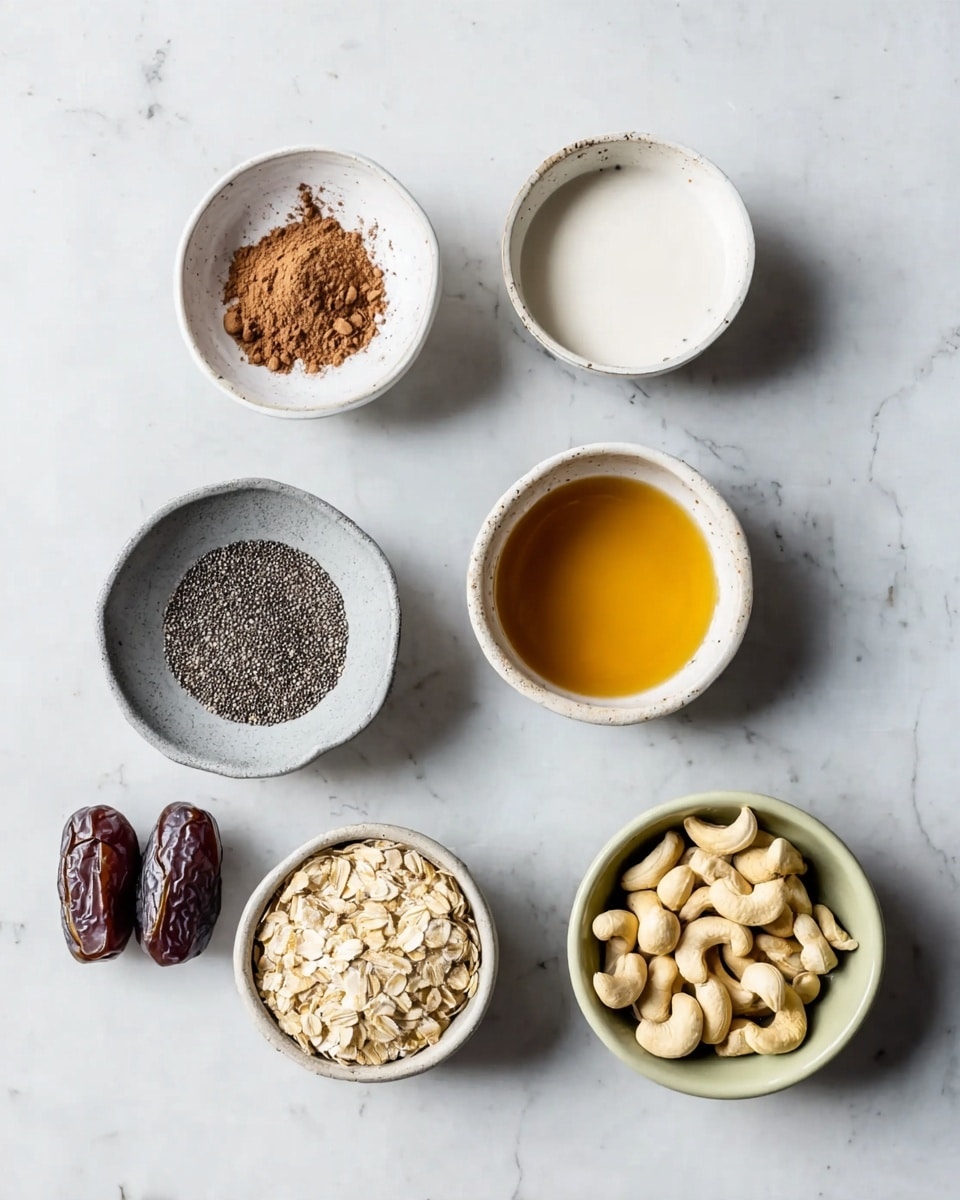 The image shows seven different small bowls and ingredients placed on a white marbled texture. One white bowl holds light brown cocoa powder, another white bowl contains smooth white liquid, and a third white bowl has a golden honey-like syrup. A gray bowl holds small black chia seeds. A pale green bowl is filled with rolled oats, while a white bowl contains whole cashew nuts. Three dark brown dates without bowls are also placed on the surface near the bowls. photo taken with an iphone --ar 4:5 --v 7