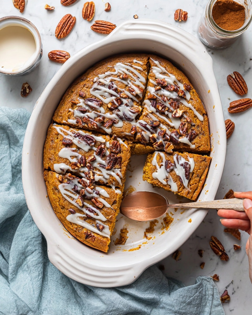 A round, thick pumpkin cake with a golden-brown color sits in a white oval baking dish. The cake is cut into square pieces and has one piece lifted slightly above the rest, showing its dense, moist texture inside. On top, there are dark brown pecan pieces scattered evenly, with thin white icing drizzled all over the surface, adding a glossy finish. Around the dish, there are whole pecans on a white marbled surface, a small bowl of extra icing with a whisk inside, a cinnamon spice jar, and a woman’s hand holding the lifted piece. A light blue cloth is softly placed to the side. Photo taken with an iphone --ar 4:5 --v 7